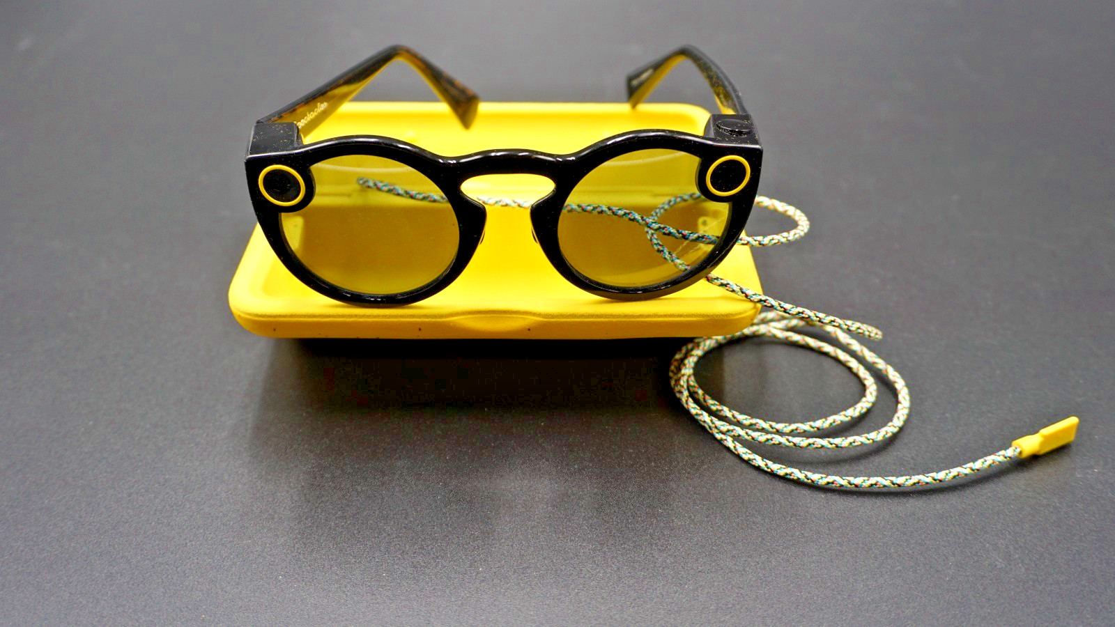 Snapchat Spectacles Generation One. Glasses, charging cord and case.